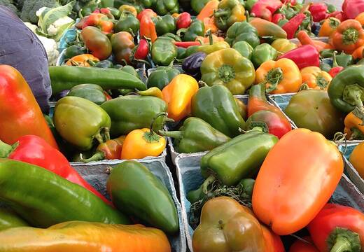 Peppers in crates on a market table