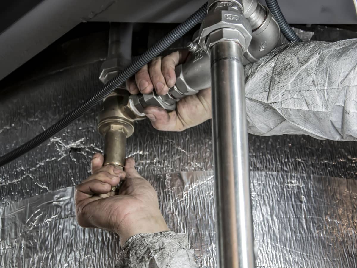 Copper pipework being fitted in a basement